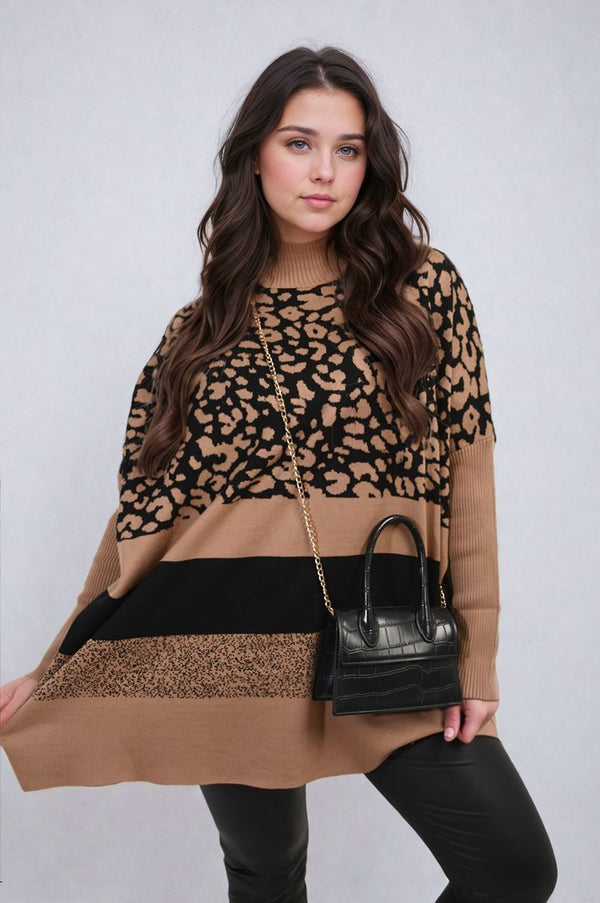 Woman wearing an Oversized Leopard Print High Neck Knitted Jumper, posing with a black purse, embodying a chic and cozy style.