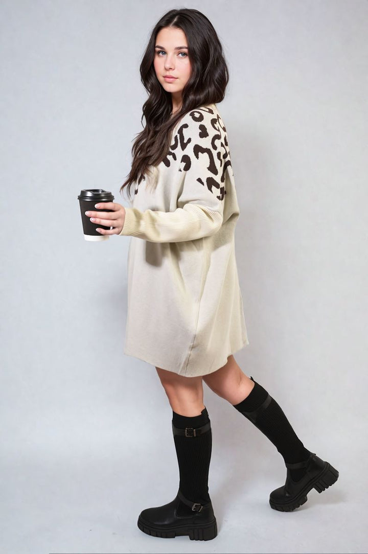 Woman holding a coffee cup, wearing the Abigail Leopard Print Knitted Long Sleeve Jumper, showcasing its stylish design and cozy fit.