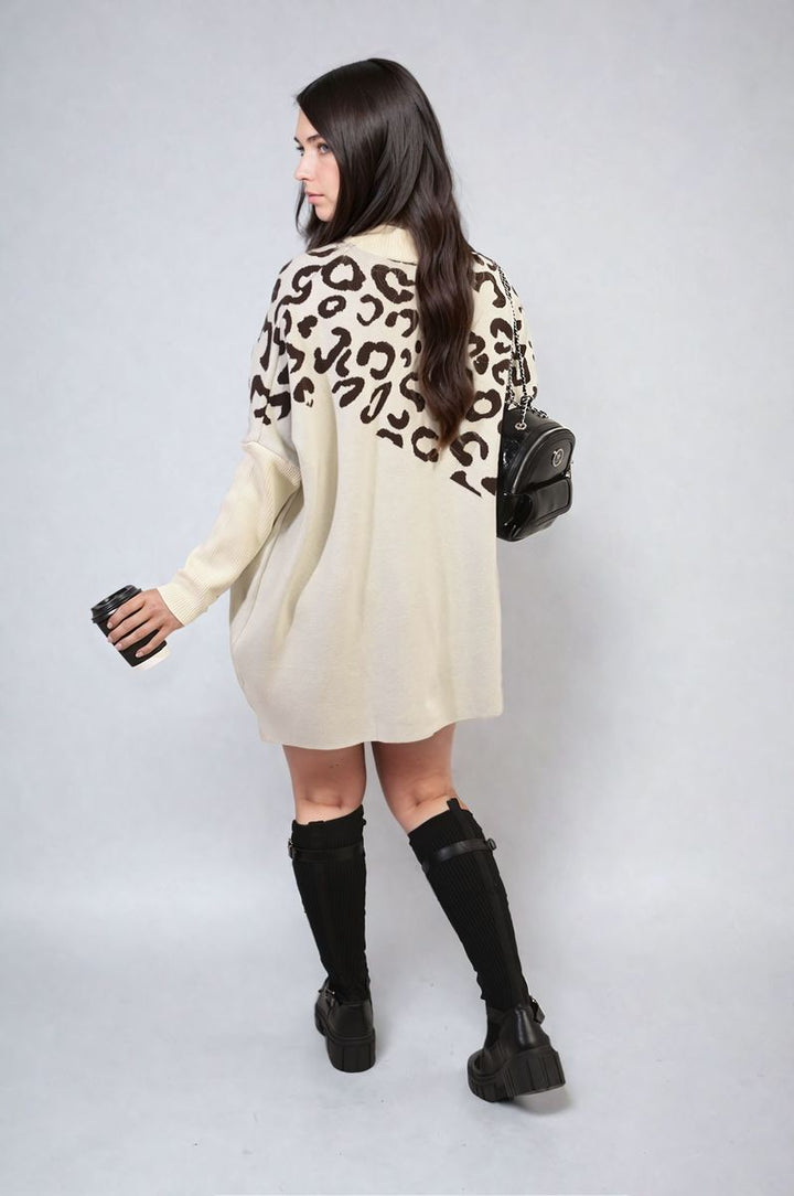 Woman wearing the Abigail Leopard Print Knitted Long Sleeve Jumper, accessorized with a black purse and boots, holding a coffee cup.