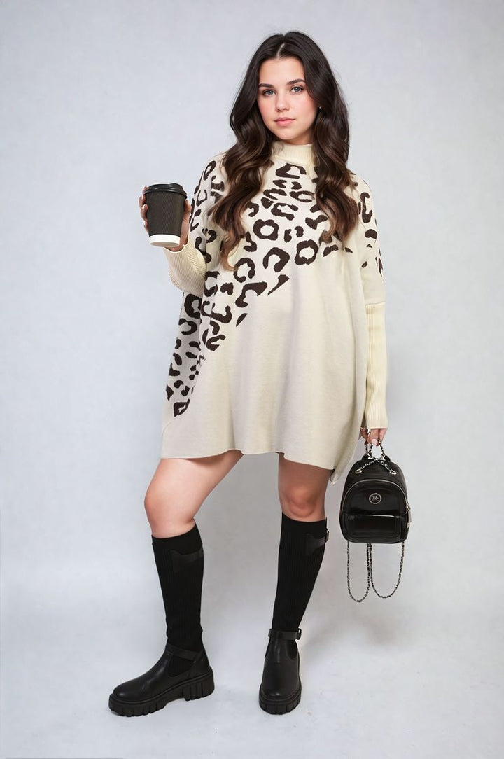 Woman holding a coffee cup, wearing the Abigail Leopard Print Knitted Long Sleeve Jumper, showcasing its stylish design and cozy fit.