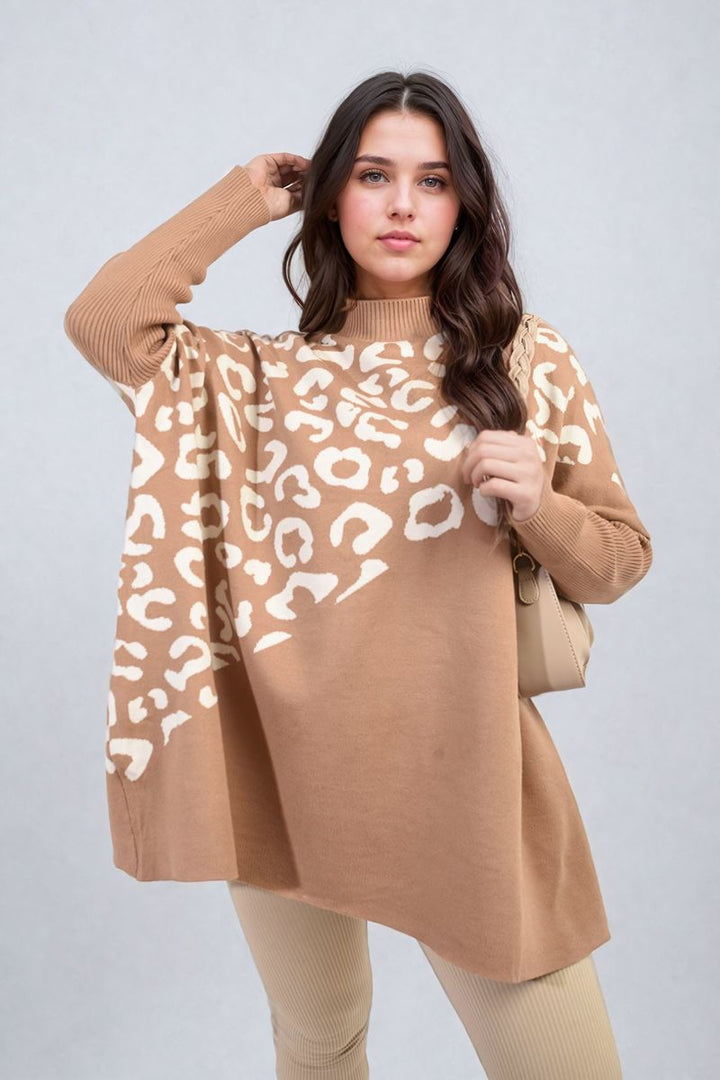 Woman in a leopard print knitted long sleeve jumper, posing with a focus on the stylish design, highlighting cozy and fashionable features.