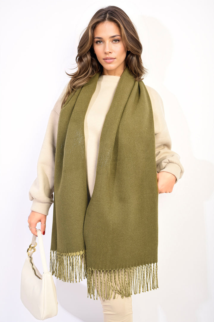 Woman wearing a Winter Oversized Scarf with Tassel, showcasing its plush texture and stylish tassels, perfect for cozying up in cold weather.