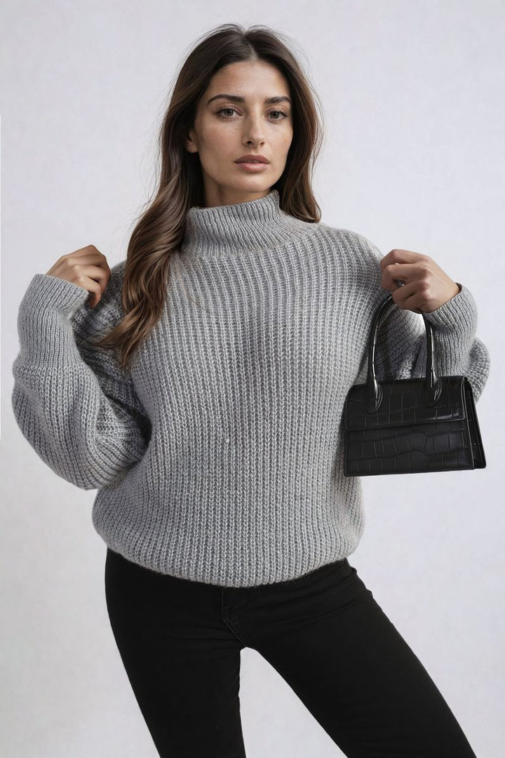 Woman wearing the Alejandra Buttons Long Sleeves Chunky Knit Top, showcasing its cozy knit texture and button details, ideal for stylish layering.