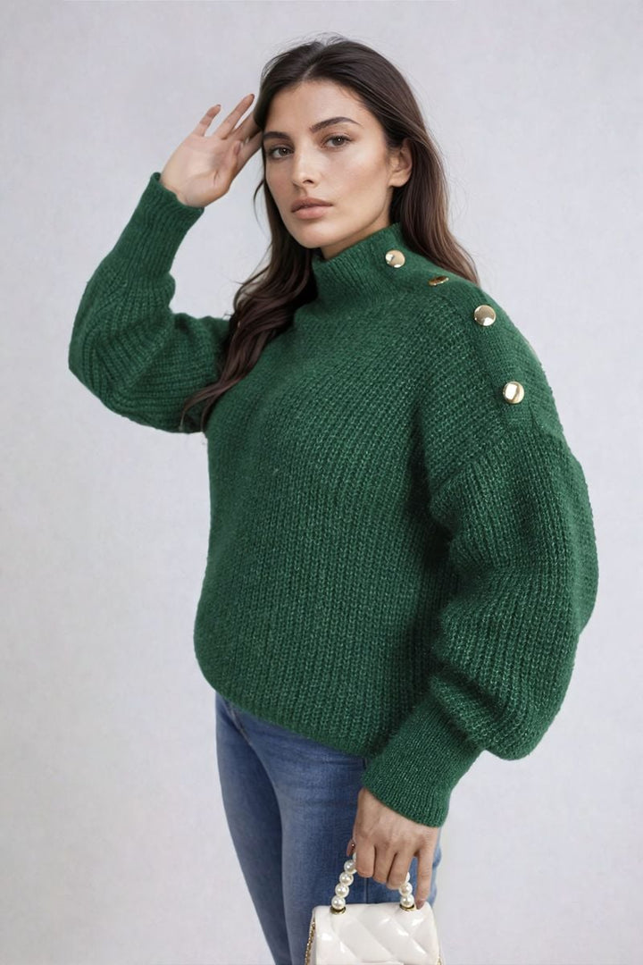 Woman wearing the Buttons Long Sleeves Chunky Knit Top, showcasing its chunky knit texture and button details, complemented by a white purse in hand.