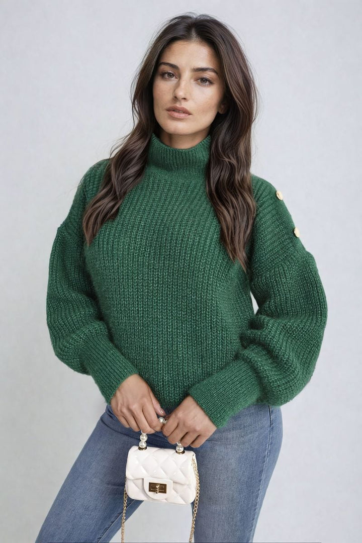 Woman wearing the Buttons Long Sleeves Chunky Knit Top, showcasing its chunky knit texture and button details, while holding a white purse.