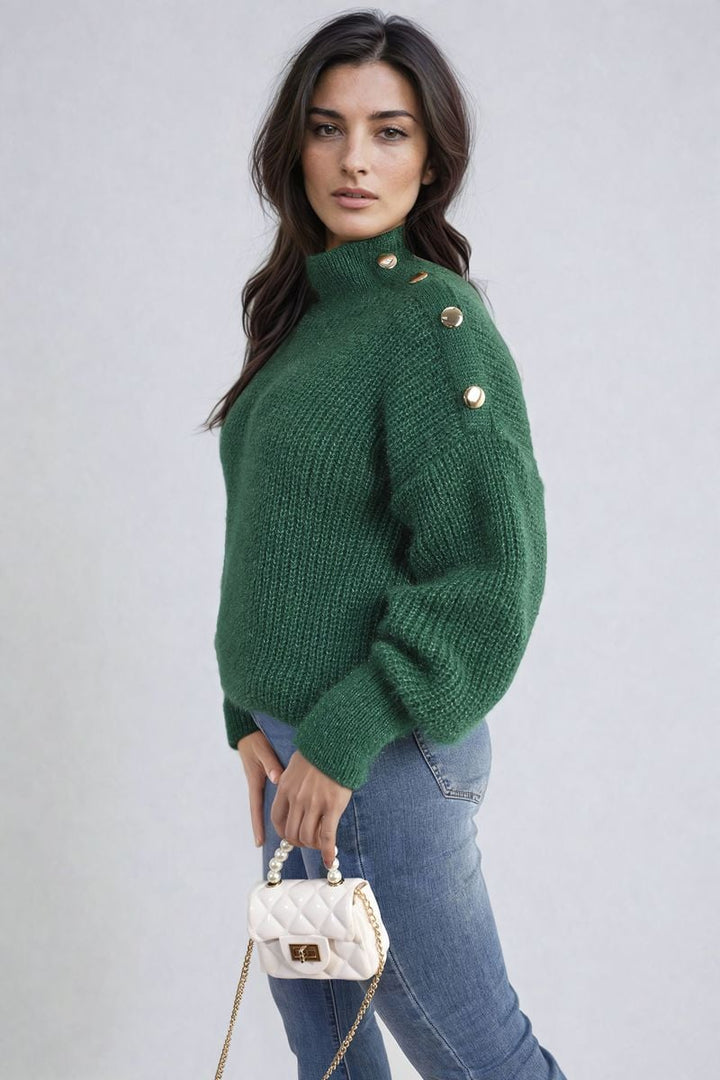 Woman wearing Buttons Long Sleeves Chunky Knit Top, showcasing its chunky knit texture and button details, paired with jeans and holding a white purse.