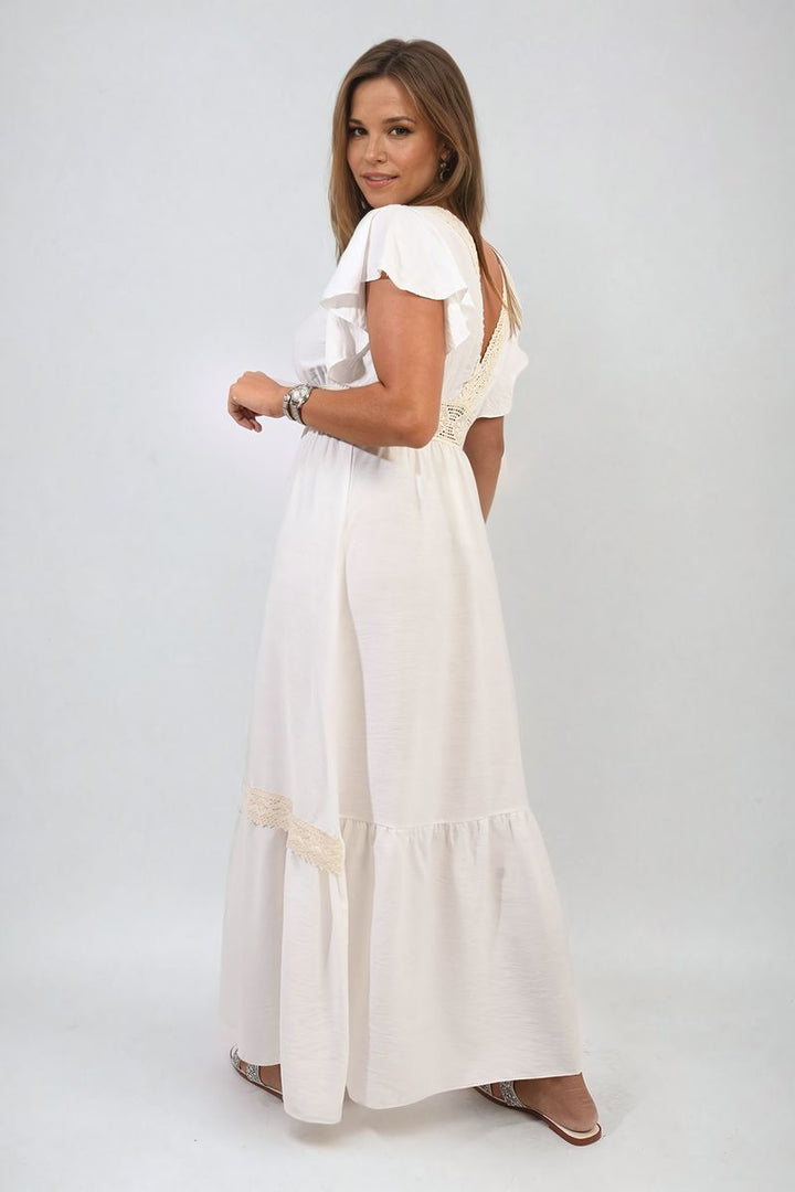 Woman wearing the Alejandra V-neck Lace Trim Maxi Dress, showcasing its elegant design, lace details, and flowing silhouette, perfect for stylish holiday or special occasions.