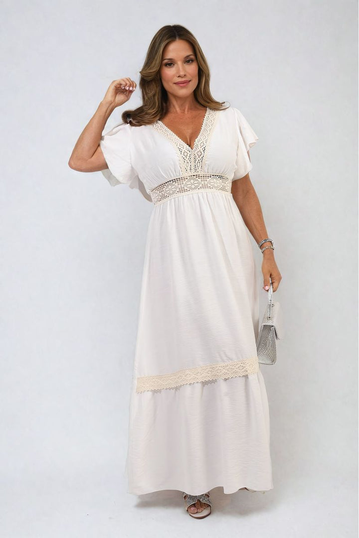 V-neck Lace Trim Maxi Dress worn by a woman, showcasing its elegant design and flowing silhouette, perfect for stylish holiday occasions or sophisticated events.