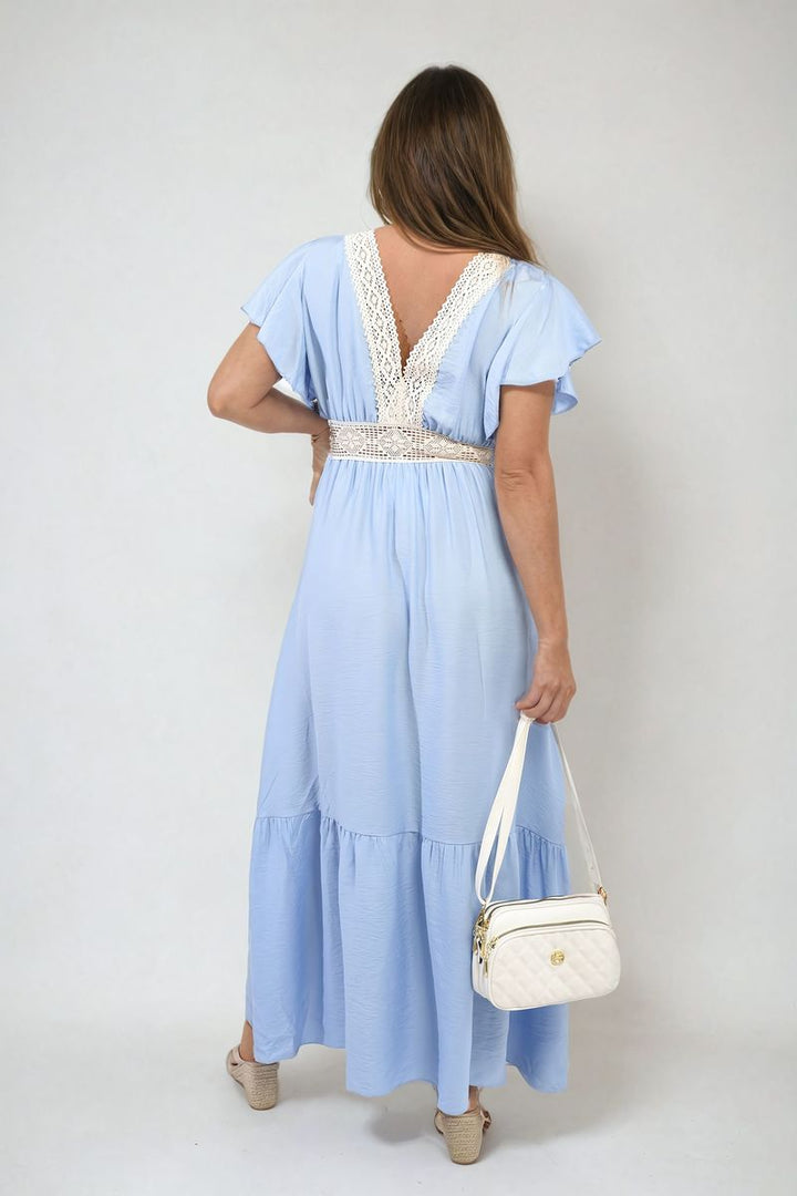 Woman in V-neck Lace Trim Maxi Dress holding a white handbag, showcasing the dress's elegant design with lace detailing and flowing skirt.