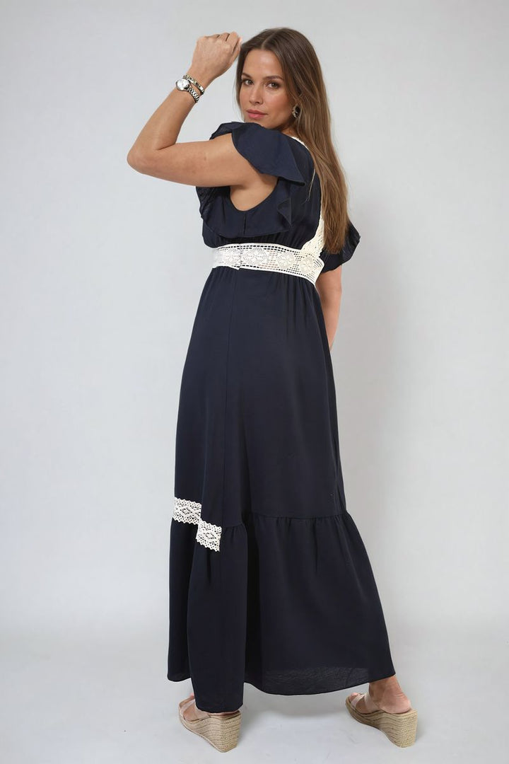 V-neck Lace Trim Maxi Dress, featuring a deep V-neckline and flowing floor-length skirt, worn by a woman, embodying elegance and sophistication.