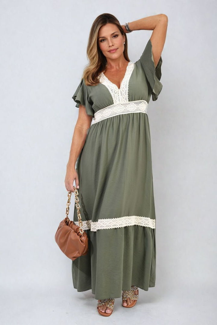 V-neck Lace Trim Maxi Dress showcased by a woman accessorized with a brown purse and rhinestone sandals, highlighting the dress's elegant and sophisticated design.