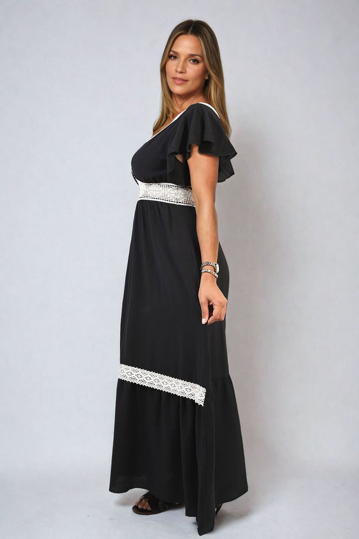 Woman modeling the Alejandra V-neck Lace Trim Maxi Dress, showcasing its elegant silhouette and lace details, perfect for sophisticated events.