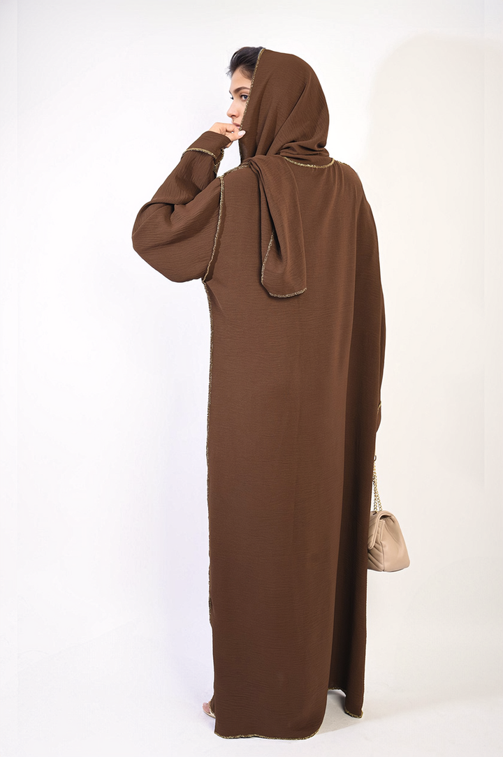 Woman wearing Long Sleeve Closed Abaya Maxi Dress with Embellished Piping, showcasing its elegant design and flattering silhouette for versatile, stylish occasions.