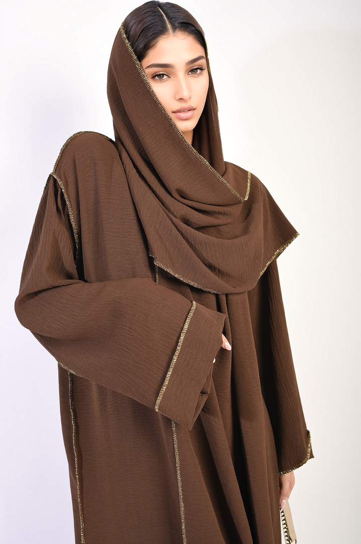 Long Sleeve Closed Abaya Maxi Dress with Embellished Piping featuring a woman in a brown robe and scarf, showcasing its elegant design and modest style.