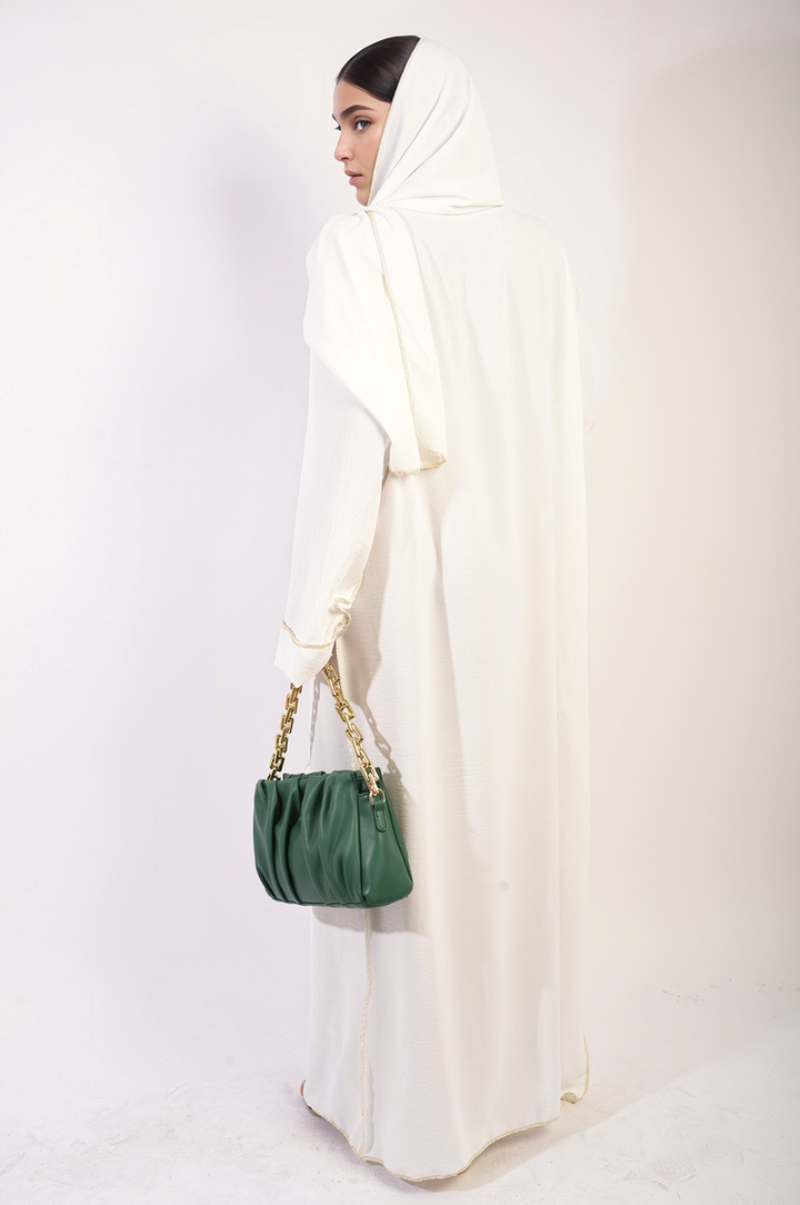 Mannequin displaying Long Sleeve Closed Abaya Maxi Dress with Embellished Piping, paired with a green purse. Scarf Included. Ideal for stylish, modest occasions.