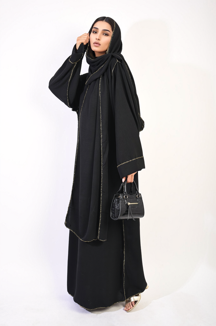 Woman in a Long Sleeve Closed Abaya Maxi Dress with Embellished Piping, holding a black purse, showcasing elegance and style from Holiday Clothes UK.