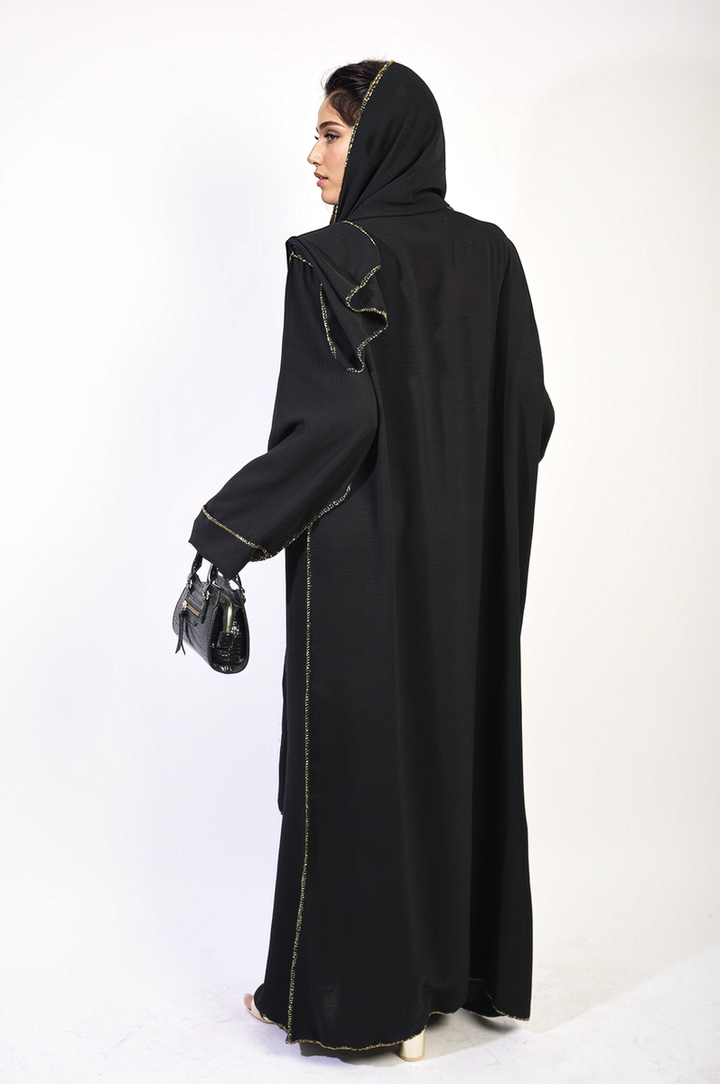 Long Sleeve Closed Abaya Maxi Dress with Embellished Piping, featuring a woman in a black robe holding a purse, highlighting the elegant design and modest style.