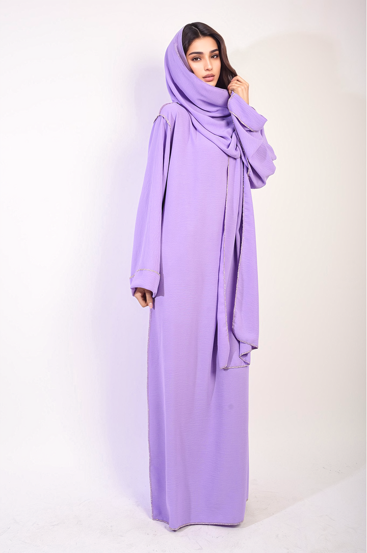 Woman wearing the Alena Long Sleeve Closed Abaya Maxi Dress with Embellished Piping, showcasing elegant design and modest fashion style.