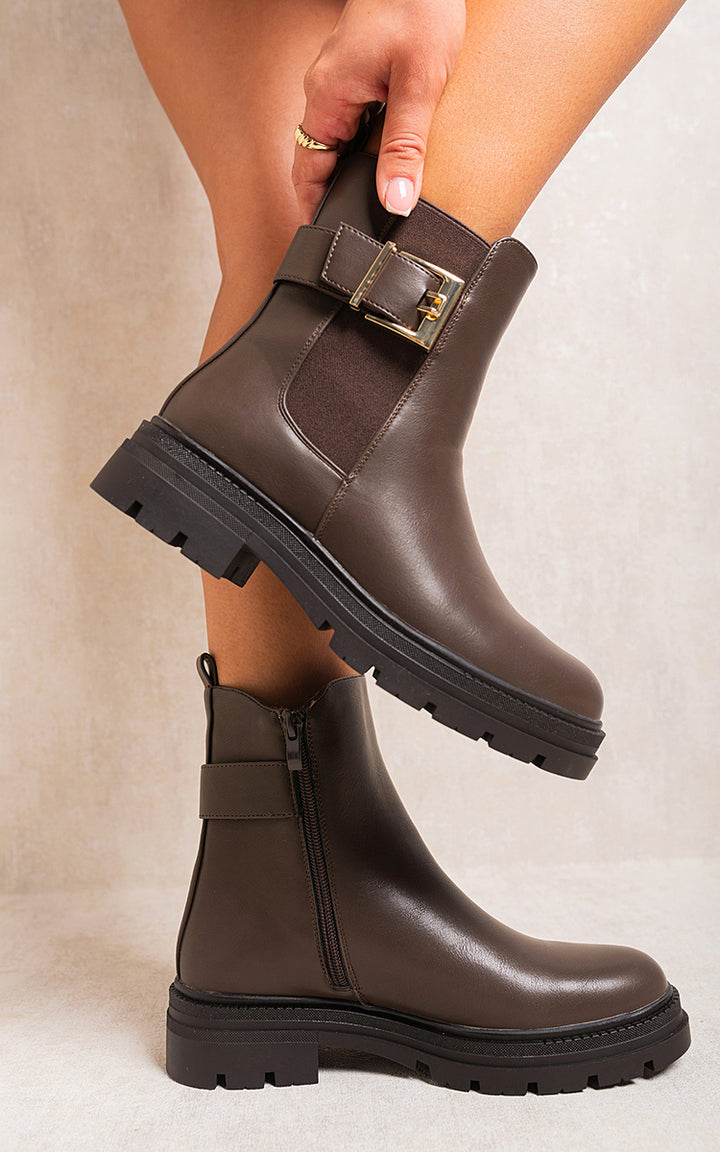 Chelsea Ankle Boots with Inner Zipper and Elastic Insert showcased on a person's legs, highlighting their sleek design and practical features for stylish wear.