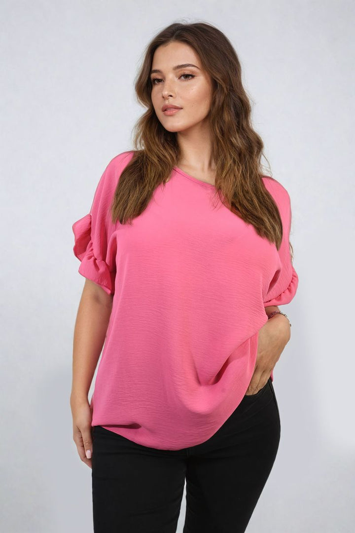 Woman wearing Alexandra Frill Sleeve Top, showcasing elegant frill sleeves, perfect for stylish holiday outfits or everyday wear from Holiday Clothes UK.