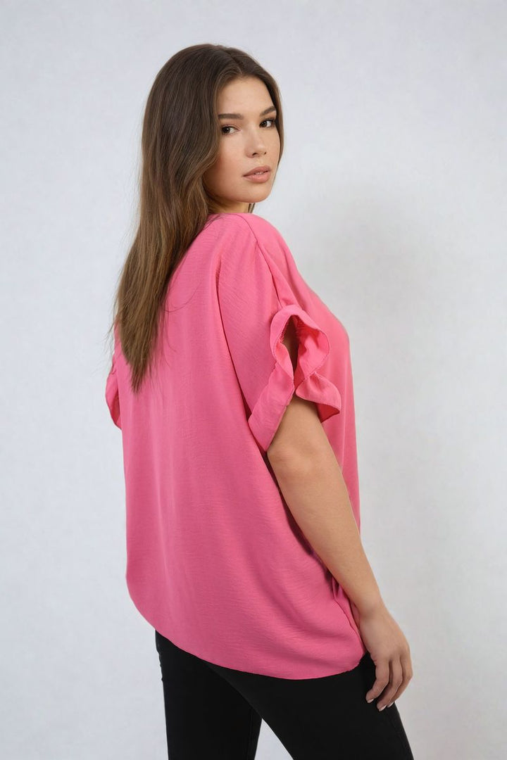 Woman wearing the Alexandra Frill Sleeve Top, showcasing its elegant frill sleeves and comfortable fabric, perfect for stylish and versatile outfits from Holiday Clothes UK.