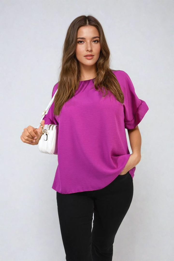 Woman wearing Alexandra Frill Sleeve Top, showcasing its elegant design with delicate frill sleeves, perfect for stylish versatility and comfort.