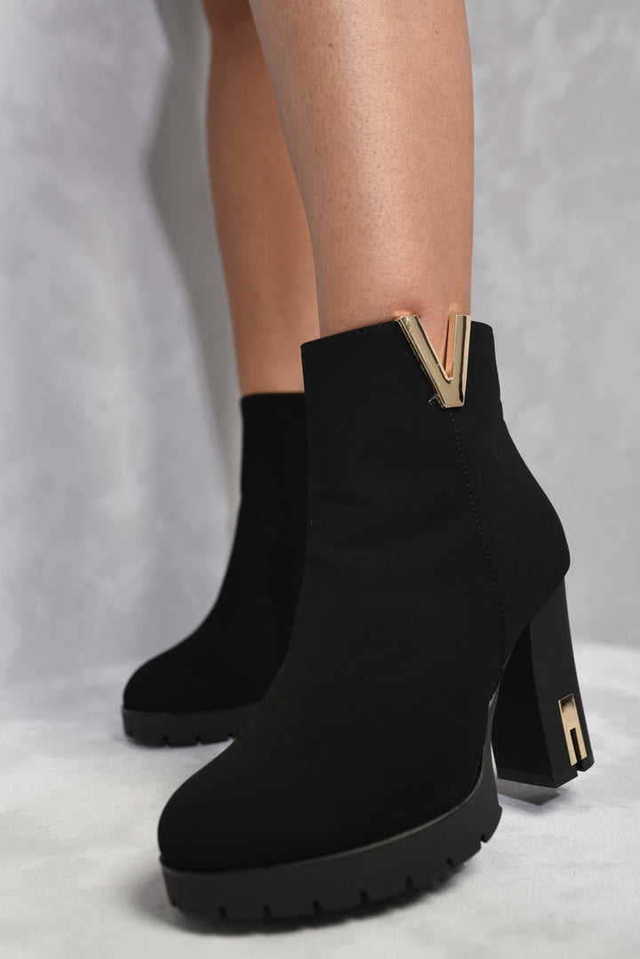 Heeled Ankle Boots with Gold Details, showcasing stylish black design and elegant gold accents, perfect for adding sophistication to your footwear collection.