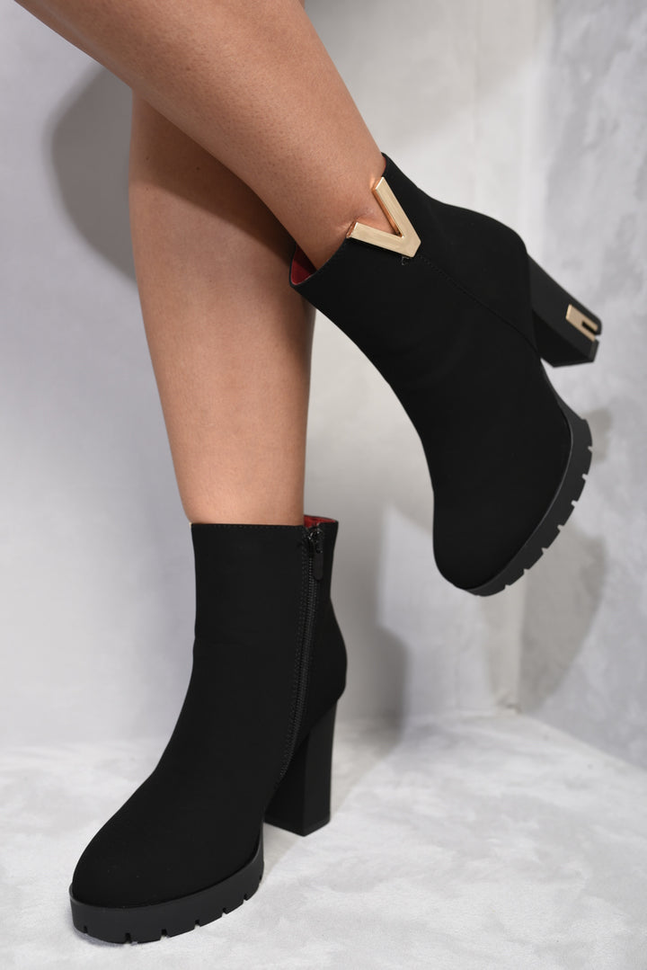 Heeled Ankle Boots with Gold Details featuring elegant gold accents and a secure zipper closure, perfect for stylish comfort and sophistication.