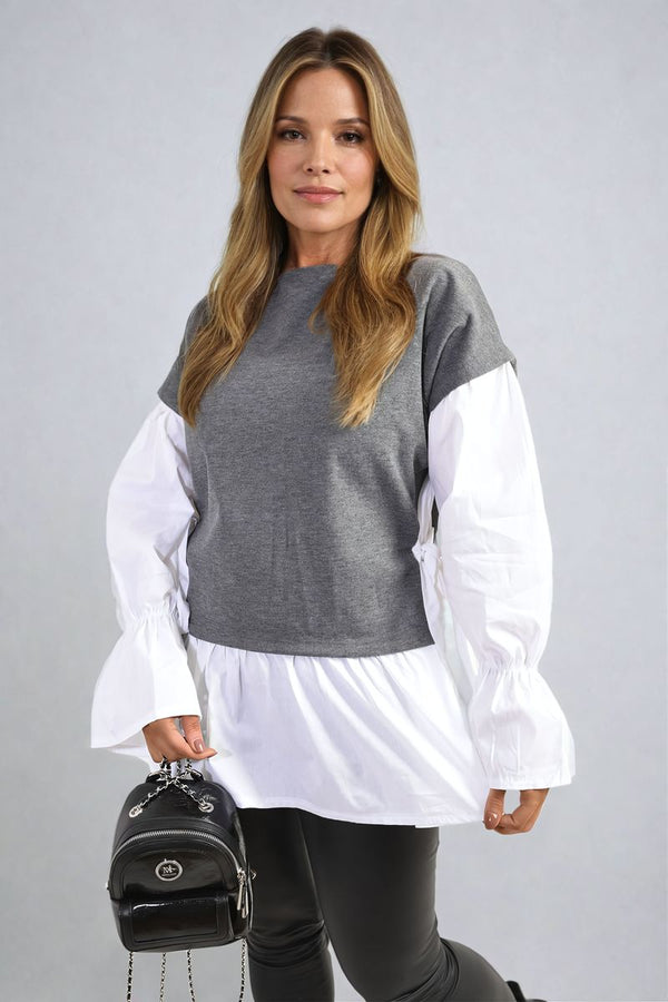 Woman models the Side Tie Contrast Long Sleeve Knit Frill Top, showcasing its stylish side tie and frill detail, perfect for a trendy, comfortable look.