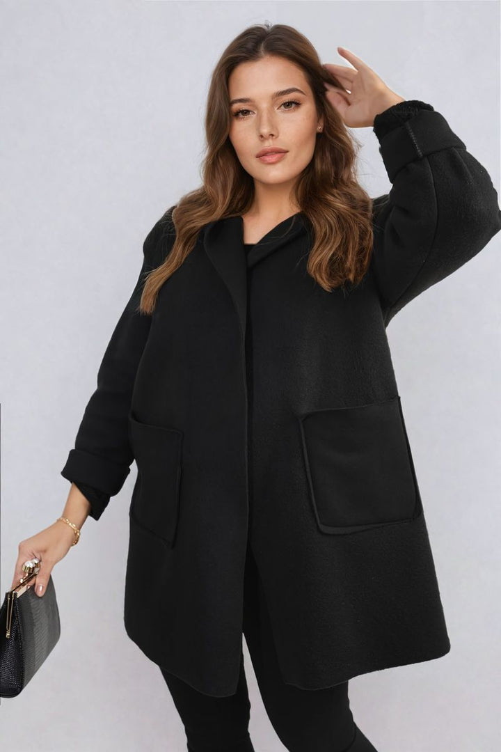 Woman wearing the Alma Open Front Folded Sleeve Jacket with Pockets, showcasing its sleek design and practical features suitable for stylish, casual outings.