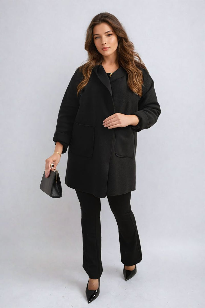 Woman in black Open Front Folded Sleeve Jacket with Pockets, holding a purse, wearing black high-heeled shoes, epitomizing stylish holiday fashion from Holiday-clothes.co.uk.