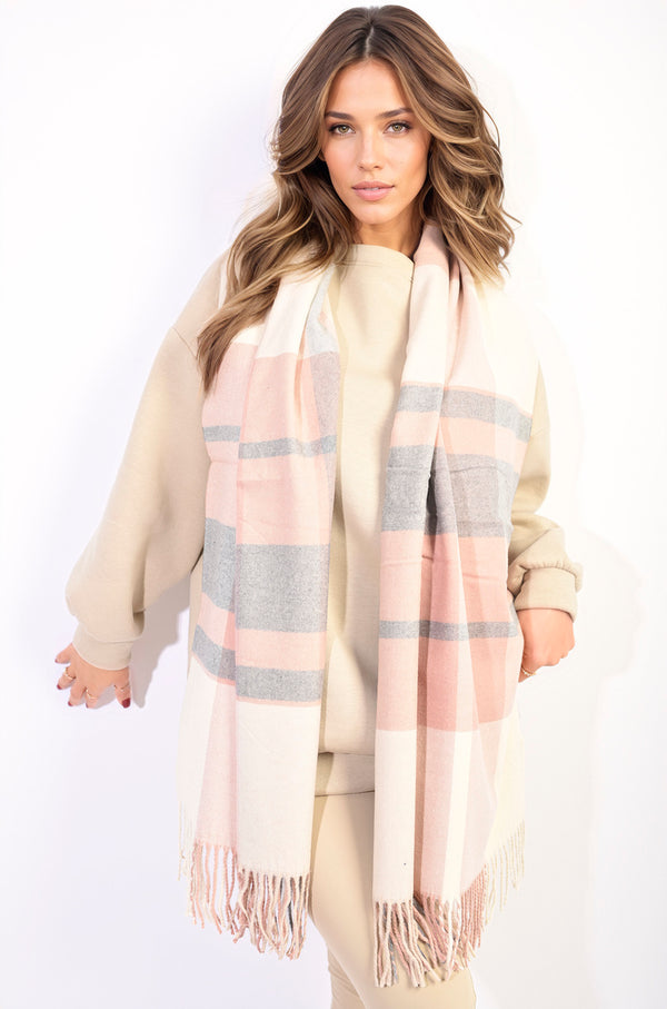 Woman wearing the Amelia Striped Tassel Scarf with colorful stripes and tassels, showcasing a chic, cozy design perfect for stylish holiday and everyday wear.