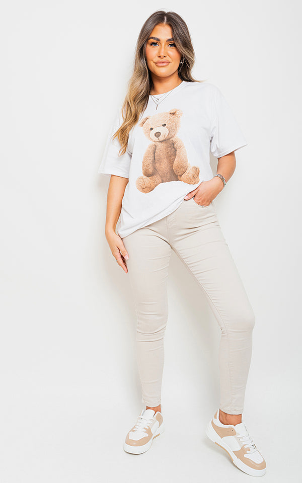 Woman wearing an oversized casual top with teddy bear print, perfect for comfort and style.