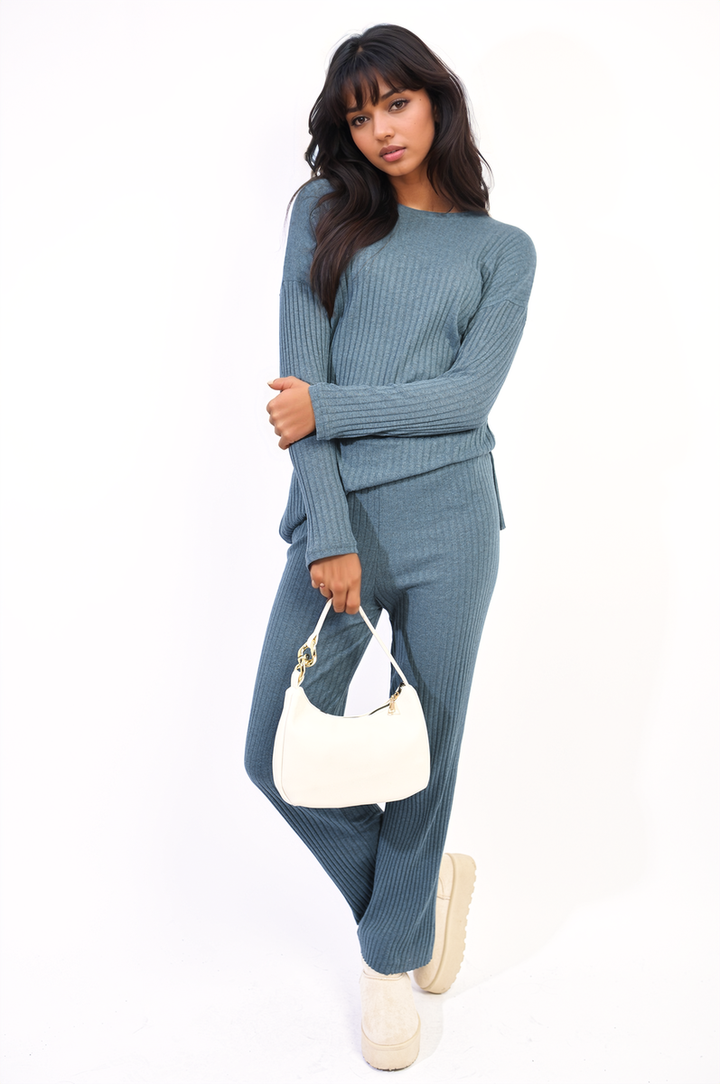 Woman wearing the Annalise Knitted Top and Trouser Co-ord Set, featuring a relaxed fit, paired with a white purse and casual shoes.