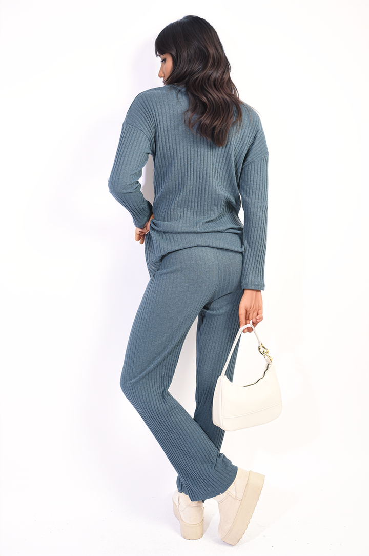 Woman wearing the Annalise Knitted Top and Trouser Co-ord Set, holding a white purse. The set features a relaxed fit, ideal for stylish comfort.