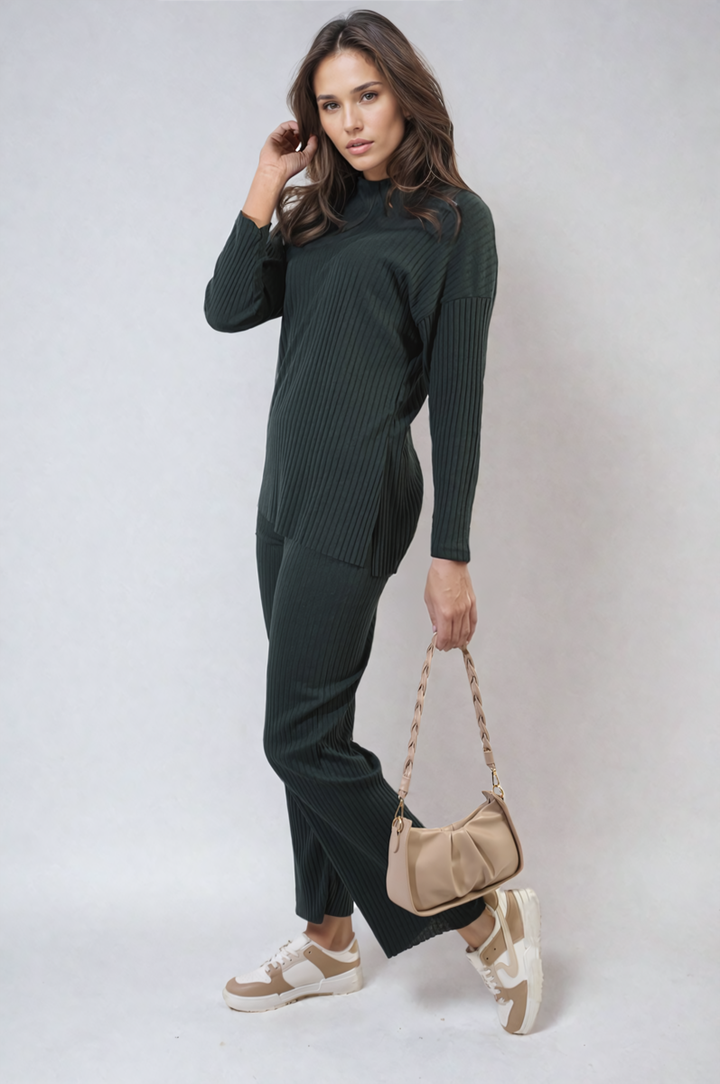 Woman holding a purse and wearing the Annalise Knitted Top and Trouser Co-ord Set, showcasing a relaxed, stylish fit ideal for everyday fashion.