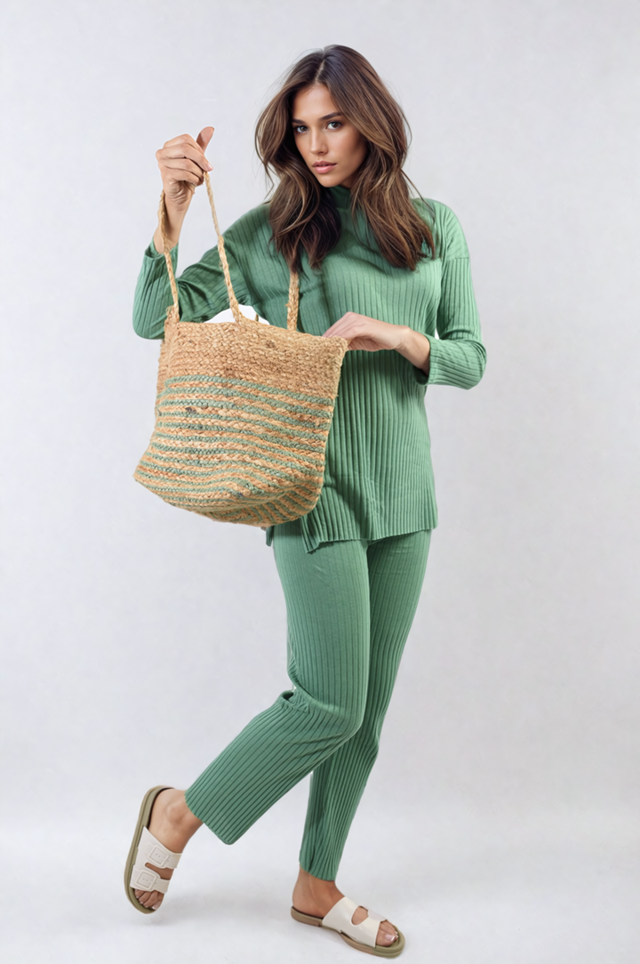 A woman holds a bag while wearing the Annalise Knitted Top and Trouser Co-ord Set, showcasing a stylish and comfortable outfit.