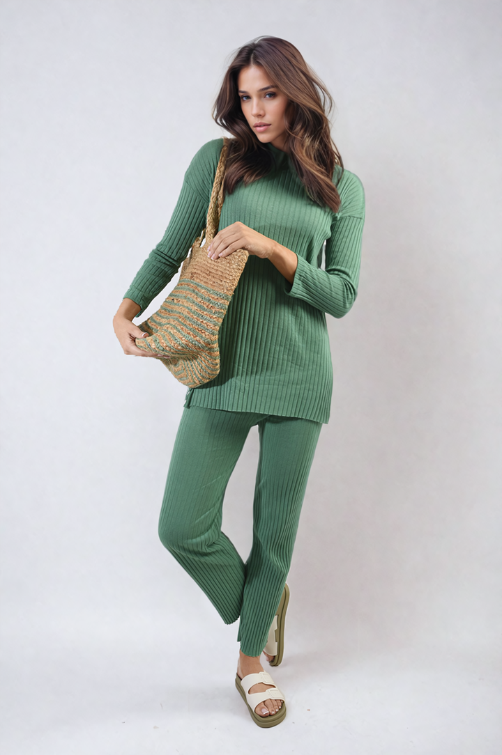 Woman in green Annalise Knitted Top and Trouser Co-ord Set, holding a knitted bag, showcasing a relaxed fit for casual comfort.