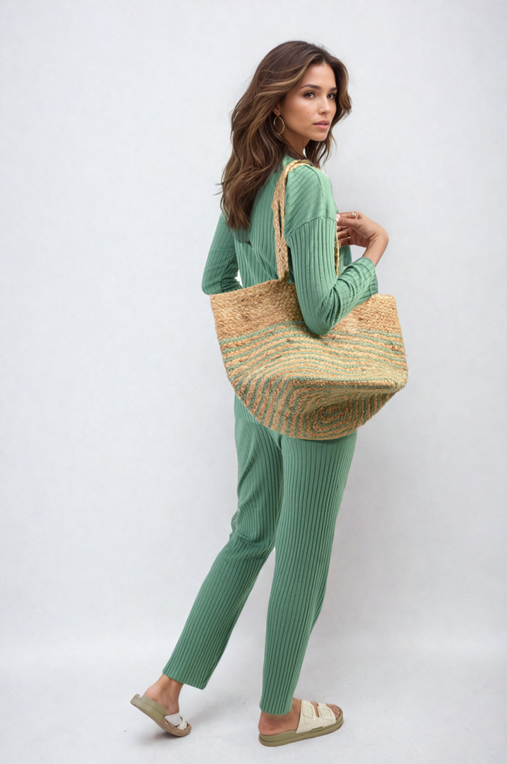 Woman in green Knitted Top and Trouser Co-ord Set holding a straw bag, showcasing a stylish and comfortable outfit from Holiday-clothes.co.uk.