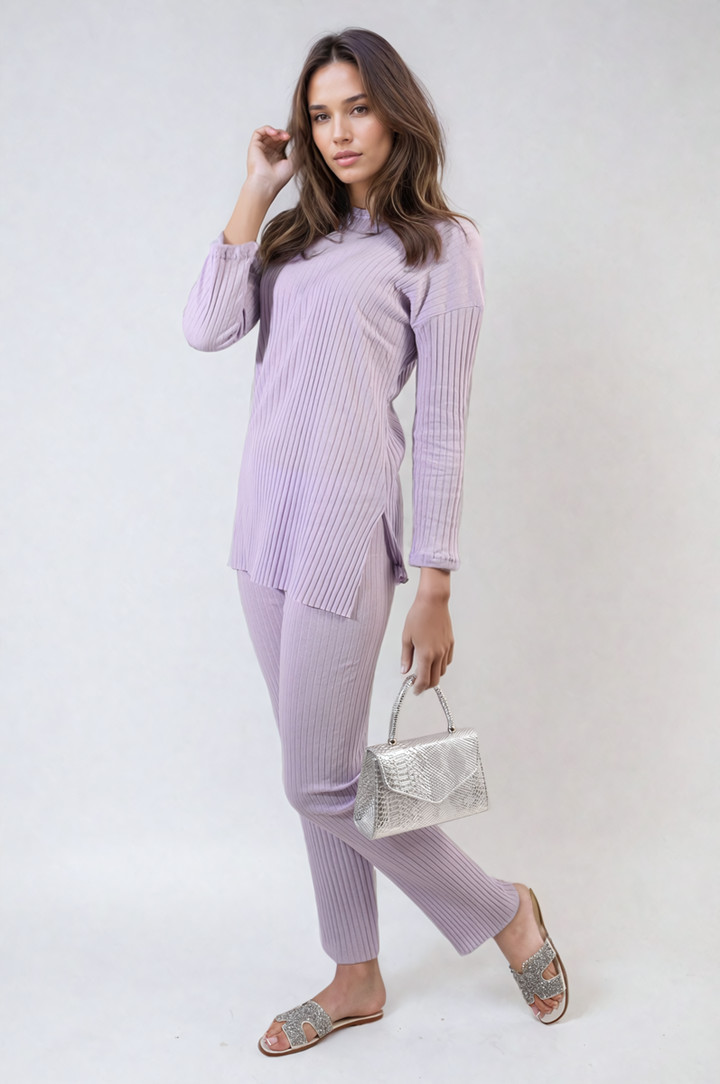 Woman wearing Annalise Knitted Top and Trouser Co-ord Set, styled with a silver purse and sandals, showcasing a chic, comfortable fashion ensemble.