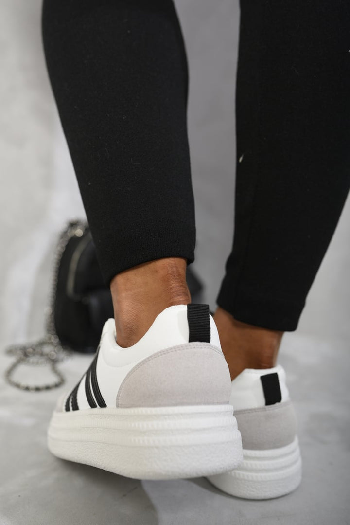 Striped Lace Up Trainers on feet, showcasing a bold design with classic laces, perfect for adding a sporty vibe to casual outfits.