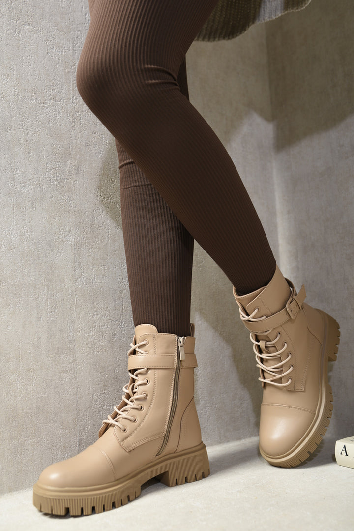 Lace Up Buckle Chunky Combat Boots with zipper, worn with brown tights, showcasing their edgy style and versatility for casual or night outings.