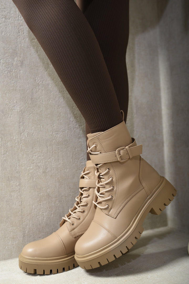 Lace Up Buckle Chunky Combat Boots with lace-up front and buckle detail, worn by a person, showcasing their edgy and versatile style.