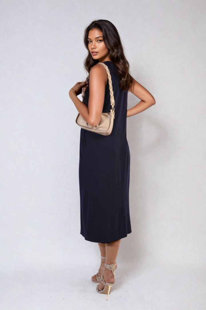 Woman wearing Sleeveless Slit Midi Dress with Side Pockets, showcasing its sleek, sleeveless design and stylish slit, ideal for chic and practical holiday wear.