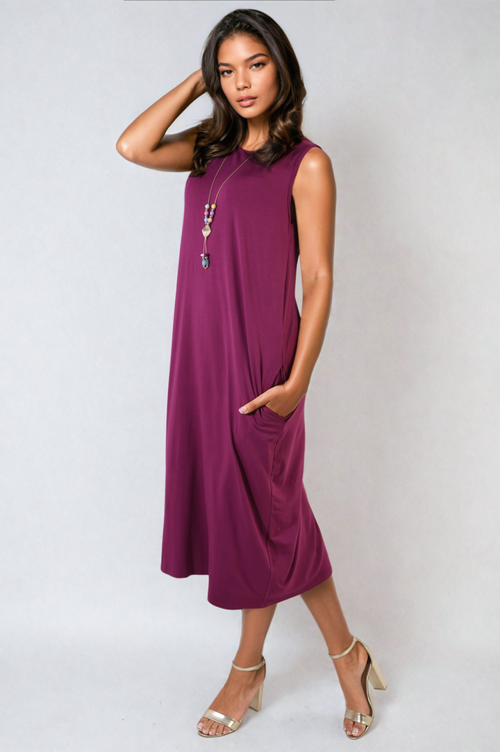 Woman modeling a Sleeveless Slit Midi Dress with Side Pockets, highlighting its elegant design and practical features.