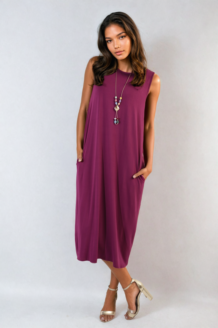 Sleeveless Slit Midi Dress with Side Pockets, featuring a sleek design with a stylish slit, worn by a woman in high heels and a colorful beaded necklace.