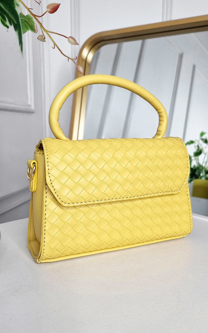 Faux Leather Quilted Handbag on a table, showcasing its structured design and luxurious quilted texture, perfect for elevating any outfit from day to night.