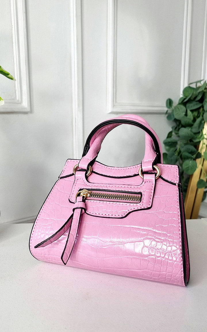 Croc Print Handbag on table, featuring chic faux leather with ample space for essentials, ideal for stylish outings.