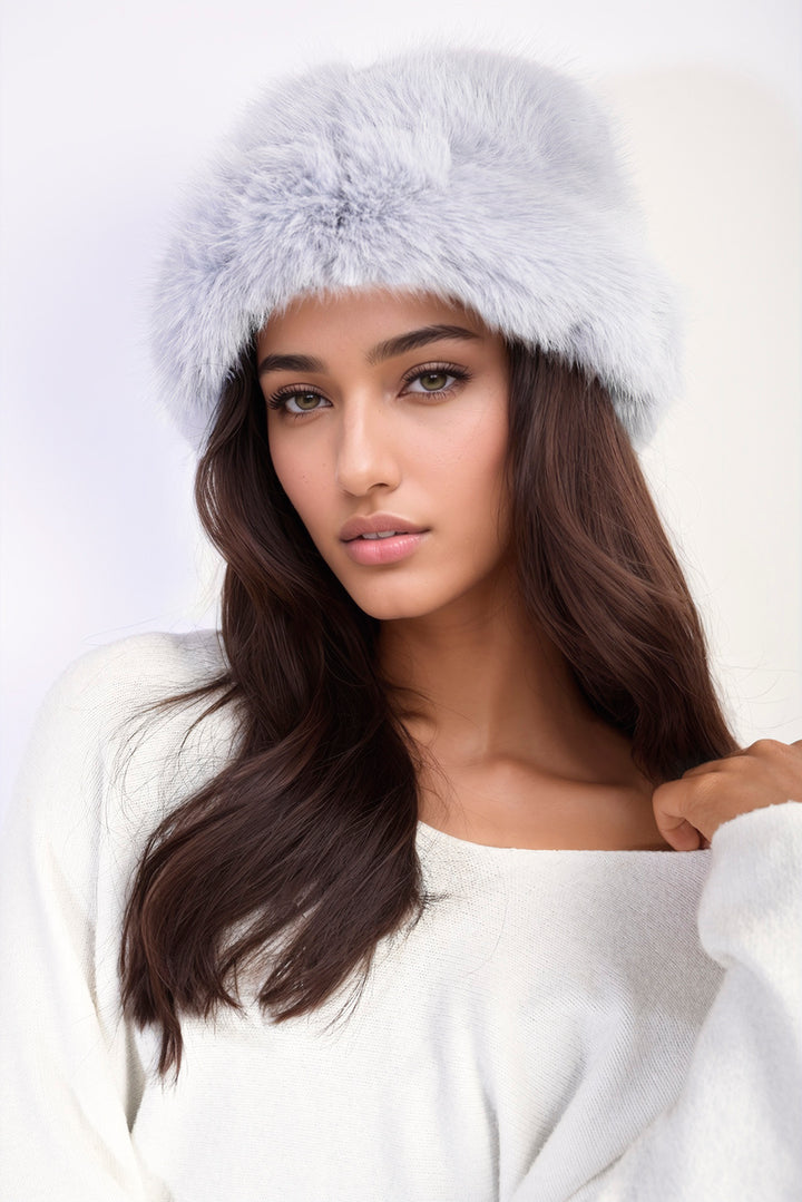 Woman wearing the Ashley Fluffy Faux Fur Winter Hat, showcasing its stylish, warm design perfect for winter fashion.