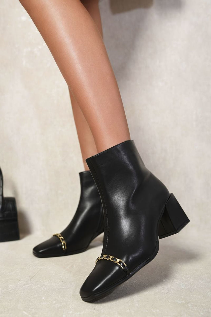 Two Tone Side Zip Block Heel Ankle Boots, featuring a chic two-tone design and block heel, modeled stylishly on legs, highlighting their elegant fit and style.